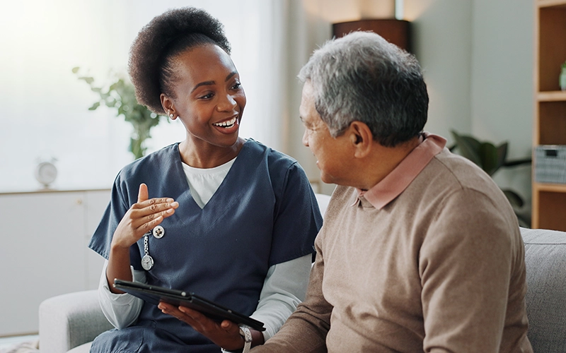 caring nurse with patient at home